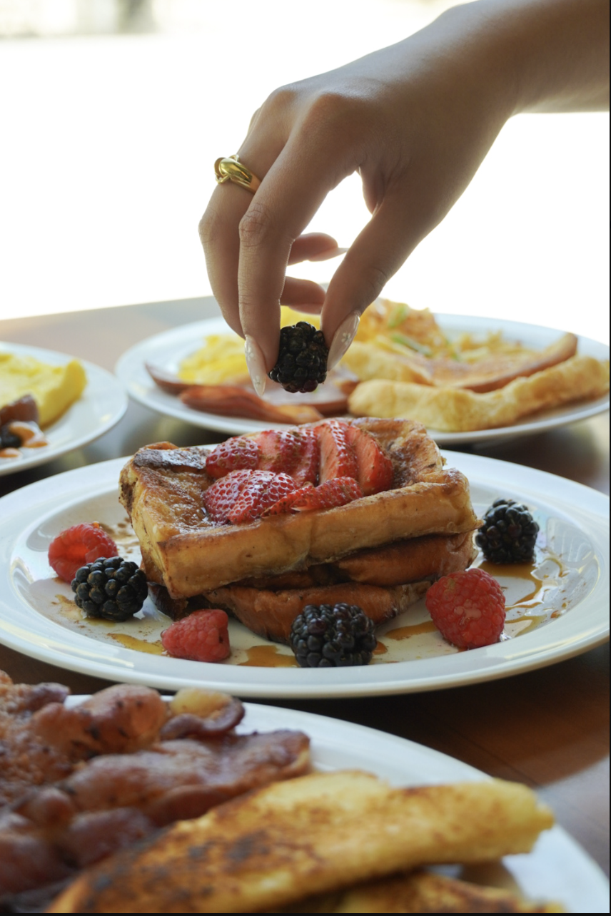 Berry-topped French toast on a sunlit brunch table